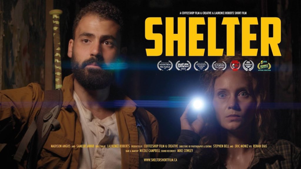 Shelter film trailer featuring the movie title, and a man standing next to a woman holding up a flashlight